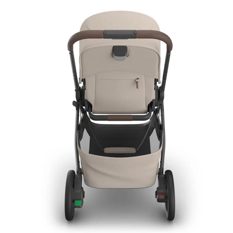 Uppababy Kona Stroller in Ada (Sandstone Mélange) with a brown handle, storage basket, and sleek design, viewed from the back.