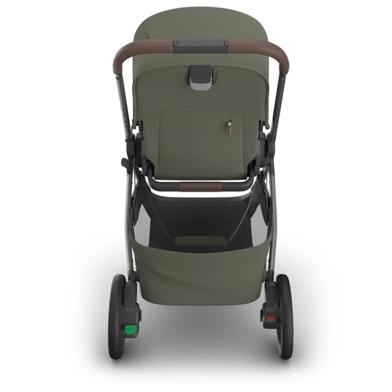 Uppababy Kona Stroller in Meadow Green with brown handle, showcasing the bassinet attachment and storage basket below.