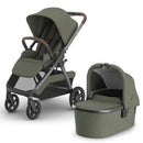 Uppababy Kona Stroller in Meadow Green with brown leather handle and detachable matching bassinet.