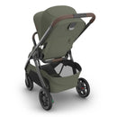Uppababy Kona Stroller in Meadow Green with a modern design, showcasing a large storage basket and ergonomic handle.
