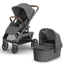 Uppababy Kona Stroller in graphite color with brown leatherette handlebar and a matching bassinet, both featuring a modern design.