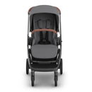 Uppababy Kona Stroller & Bassinet V3 Bundle in Rowan (Graphite), featuring a sleek gray design with a brown handlebar.