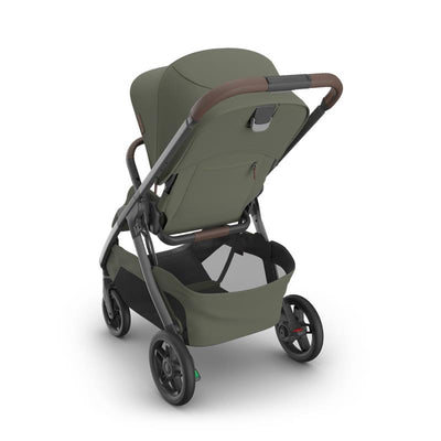 Uppababy Kona Stroller in Meadow Green with a graphite frame and chestnut leather handle, showcasing its adjustable backrest and storage basket.