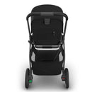 Uppababy Kona stroller in black, featuring a sleek design and rear-view angle, showcasing the handle and storage area.