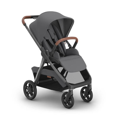 Uppababy Kona stroller in graphite with a graphite frame and saddle leather handle, featuring a spacious seat and canopy.