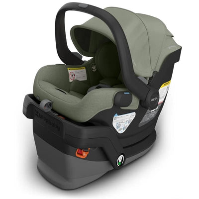Uppababy Mesa V3 infant car seat in Meadow Green, featuring a secure harness, adjustable canopy, and safety labels.