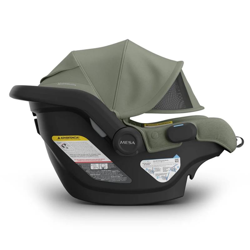 Uppababy Mesa V3 Infant Car Seat in Meadow Green, featuring a canopy, safety labels, and an ergonomic design.