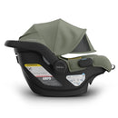 Uppababy Mesa V3 Infant Car Seat in Meadow Green, featuring a canopy, safety labels, and an ergonomic design.