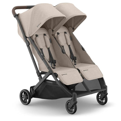 Uppababy Minu Duo Stroller in Sandstone Melange with Chestnut Leather accents, featuring two seats and adjustable canopies.