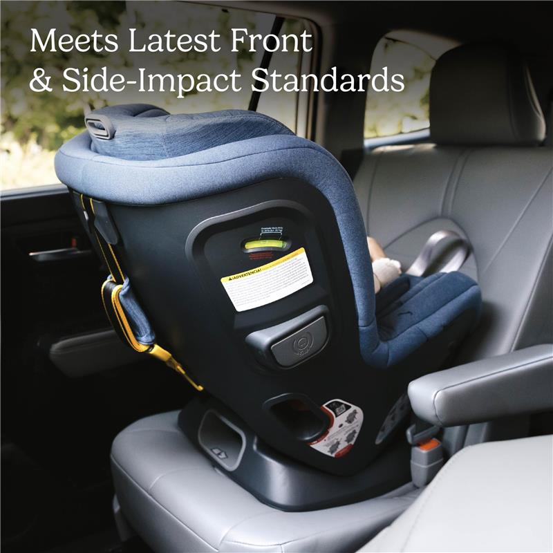 Convertible car seat in gray and navy, securely placed in a vehicle, highlighting compliance with safety standards.