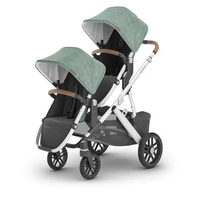 Uppababy RumbleSeat V2+ in Emmett color, featuring two seats with adjustable canopies and brown leatherette handles.