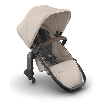 Uppababy Rumbleseat V3 in Sandstone Melange with Chestnut Leather handle, designed for a toddler or infant carrier.