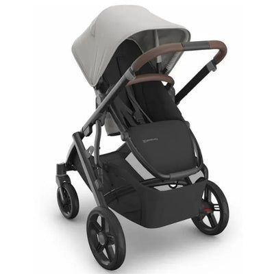 Uppababy Vista V3 stroller in gray with brown handles, featuring a spacious seat and adjustable canopy.