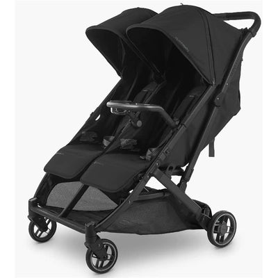 Uppababy Snack Tray for Minu Duo attached to a black double stroller with adjustable canopies and seating compartments.