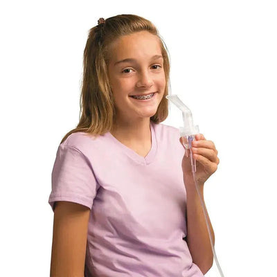 Girl with braces smiling while holding a Kitty Compressor Nebulizer inhaler.