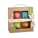 Vulli Sophie La Girafe So’Pure Cubes & Balls set featuring four colorful toys: a pink ball, blue cube, and two other textured balls, all with a giraffe design.
