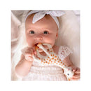 Baby holding a Vulli Sophie La Girafe teether, surrounded by soft fabric, looking directly at the camera.