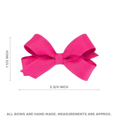 Tiny grosgrain hair bow in shocking pink, measuring approximately 2¾ inches across and 1½ inches tall.