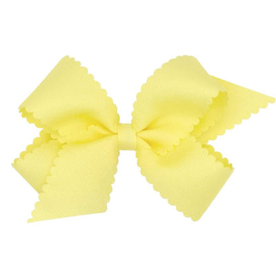 Classic medium light yellow grosgrain hair bow with scalloped edges. Ideal accessory for children’s hairstyles.