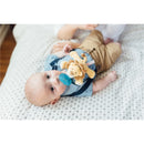 Infant lying on a patterned blanket, holding a WubbaNub pacifier featuring a cute baby lion toy.