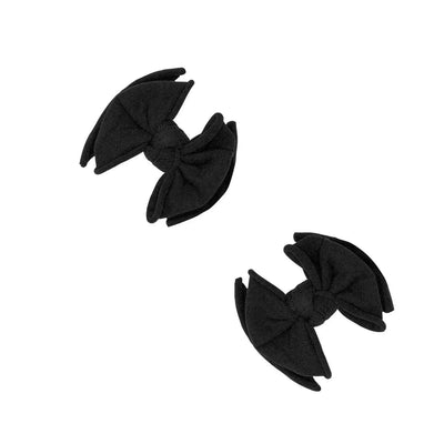 Two black Baby Bling Bows fabric hair clips for babies on a white background