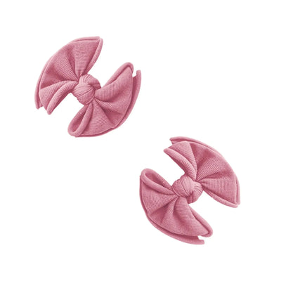 Two mauve Baby Bling Bows fabric hair clips for babies on a white background