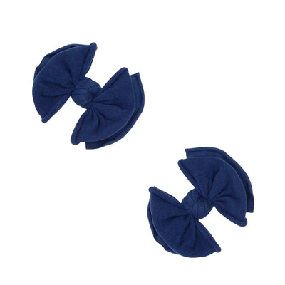 Two navy blue fabric bow hair clips by Baby Bling Bows on a white background