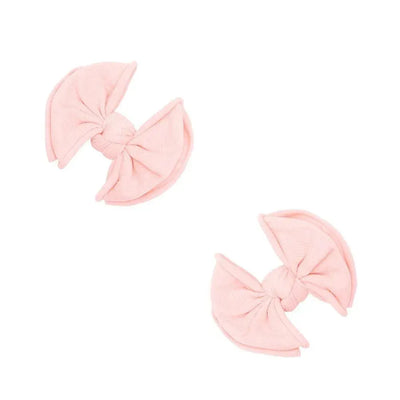 Two Baby Bling Bows rose quartz fabric hair clips for babies on a white background