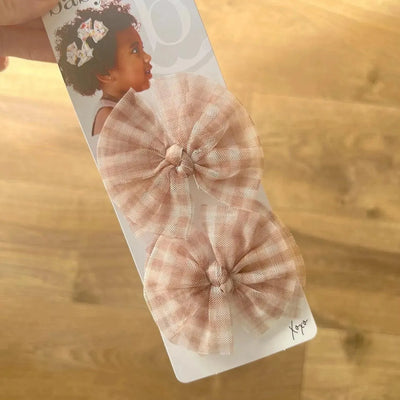 Two Baby Bling Bows blush gingham tulle hair clips on a display card.