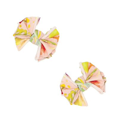 Two Baby Bling Bows printed baby fabric clips in a colorful floral pattern on a white background.